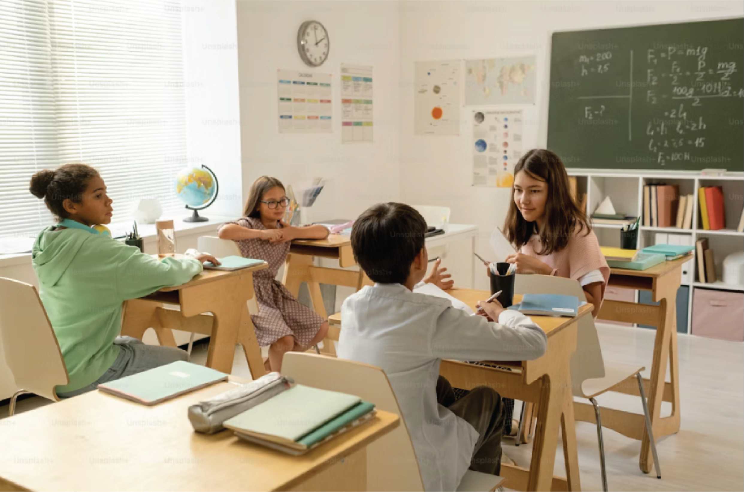 Students discussing in classroom, bright learning environment.
