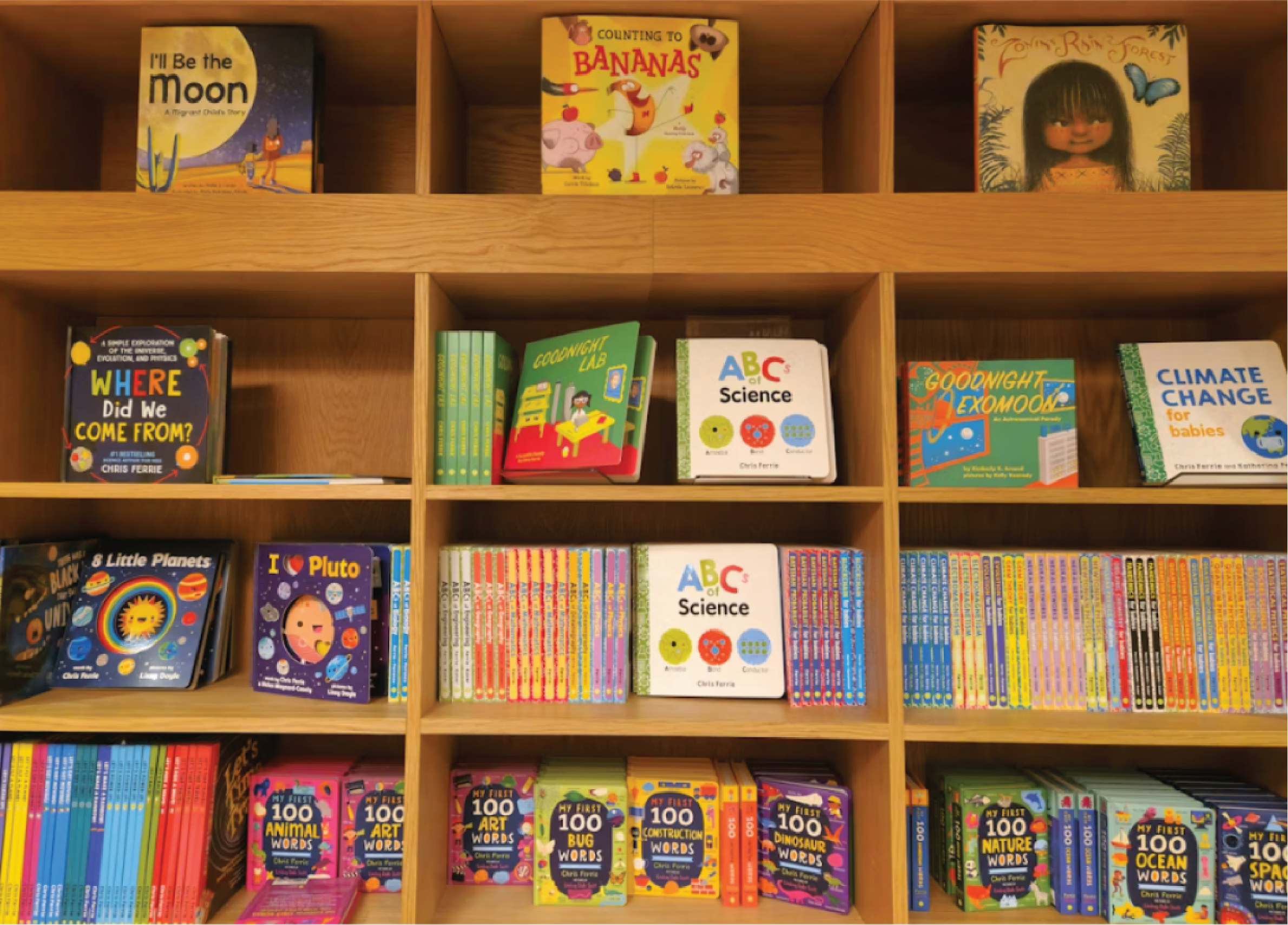 Children's books displayed on wooden shelves.