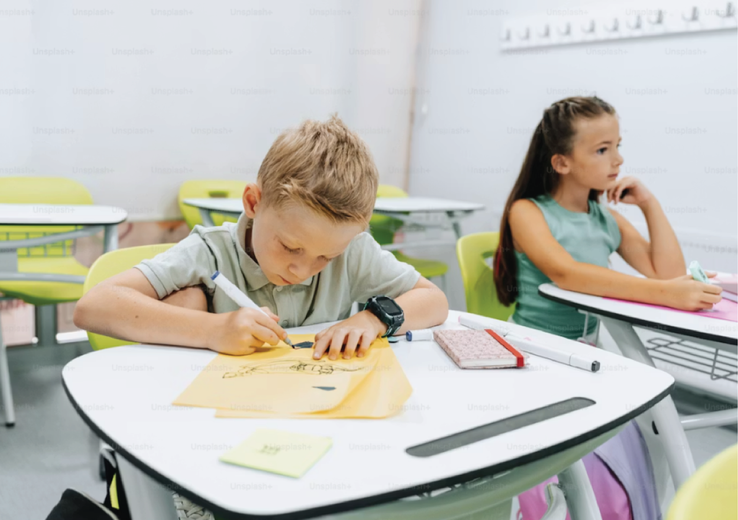 Children drawing in classroom at school