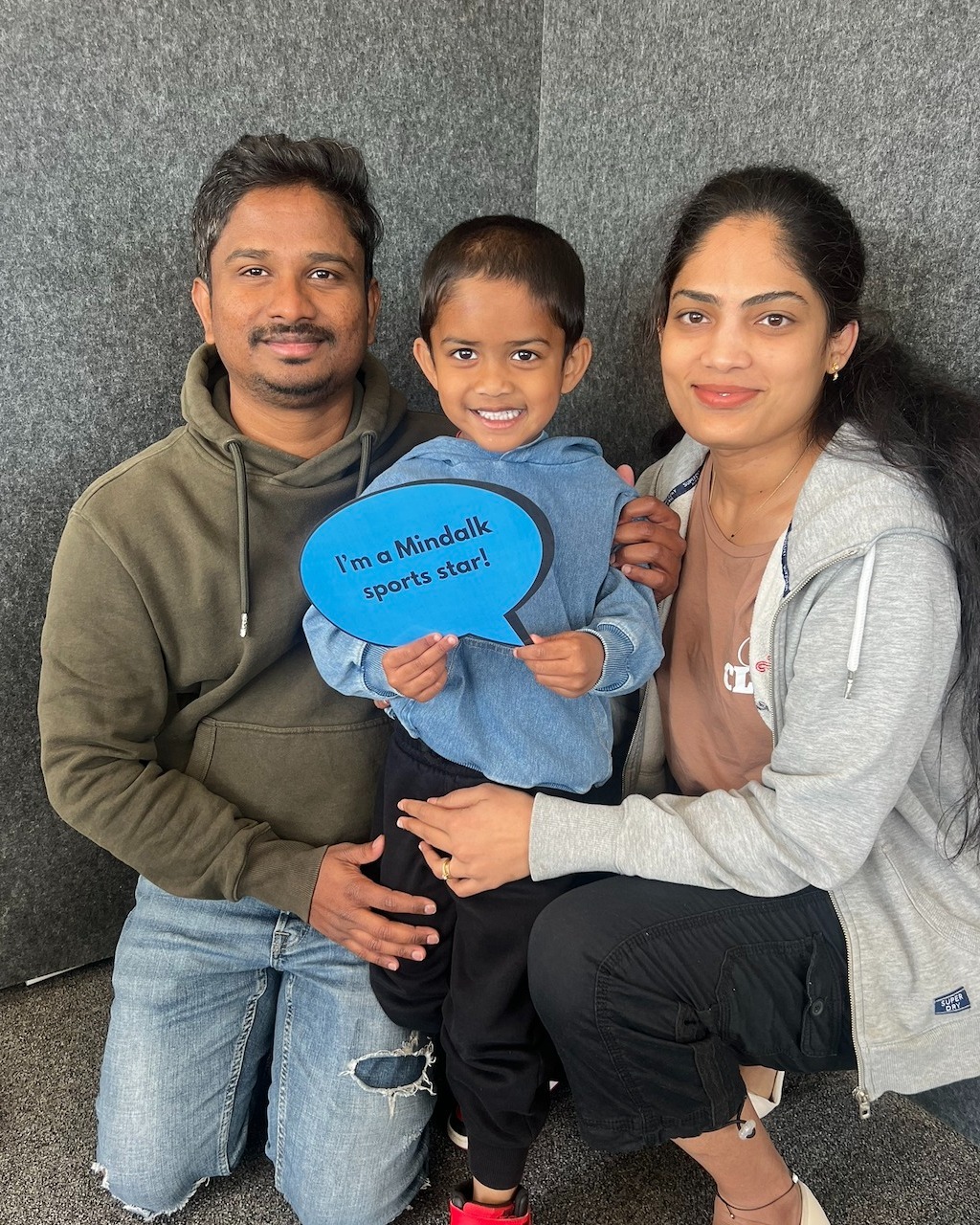 Family posing with Mindalk sports star sign.