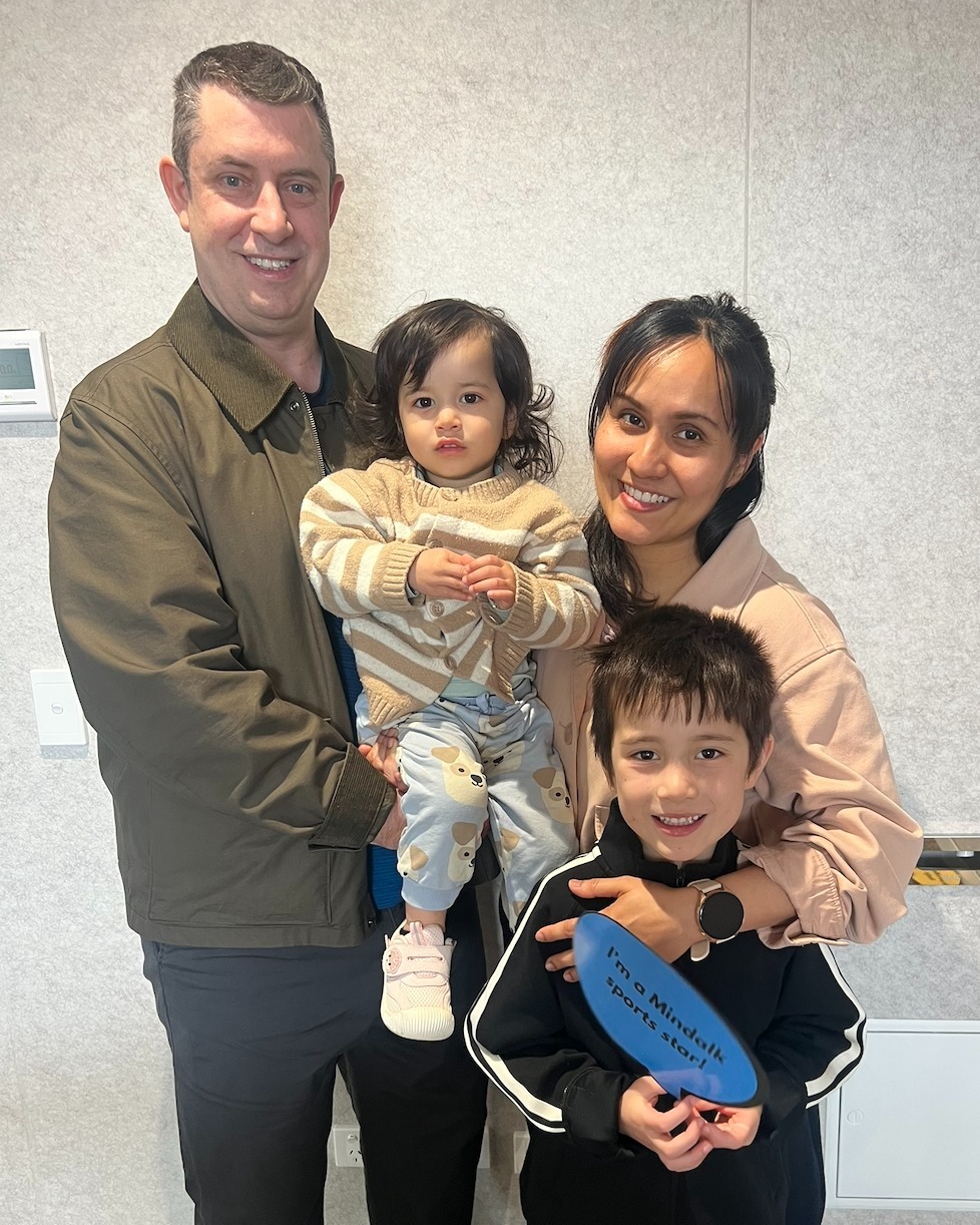 Happy family portrait indoors with two children.