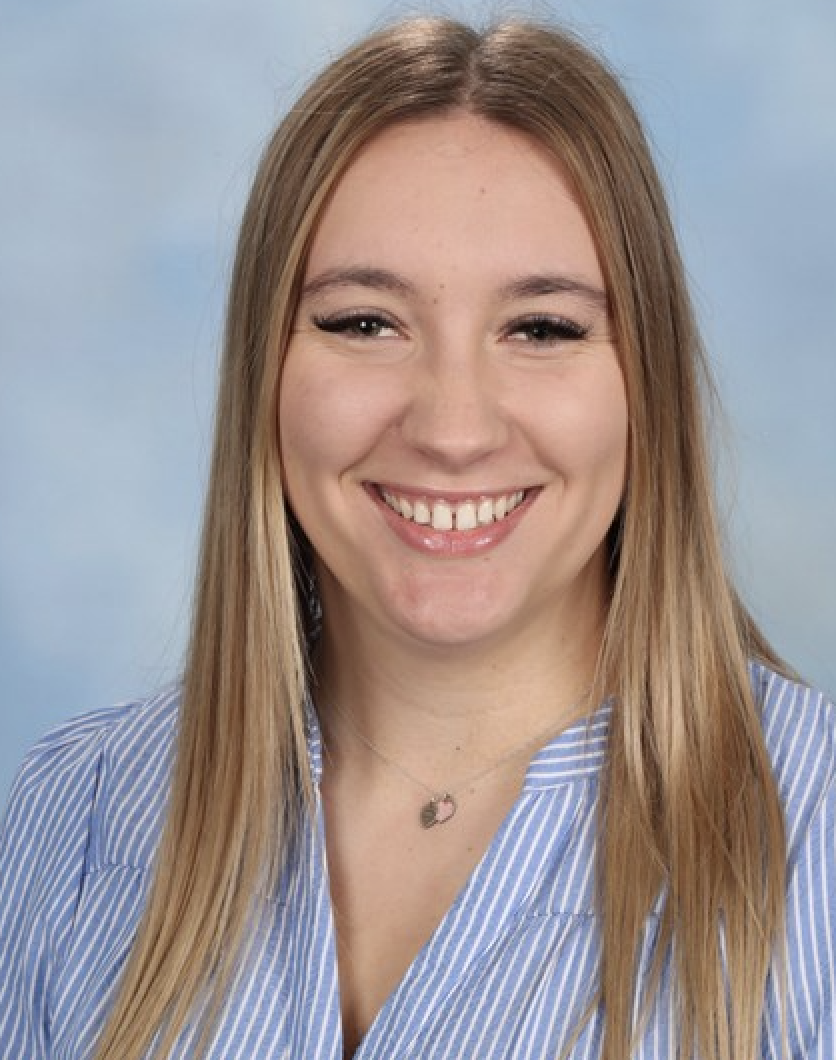 Smiling woman with long hair and striped shirt.