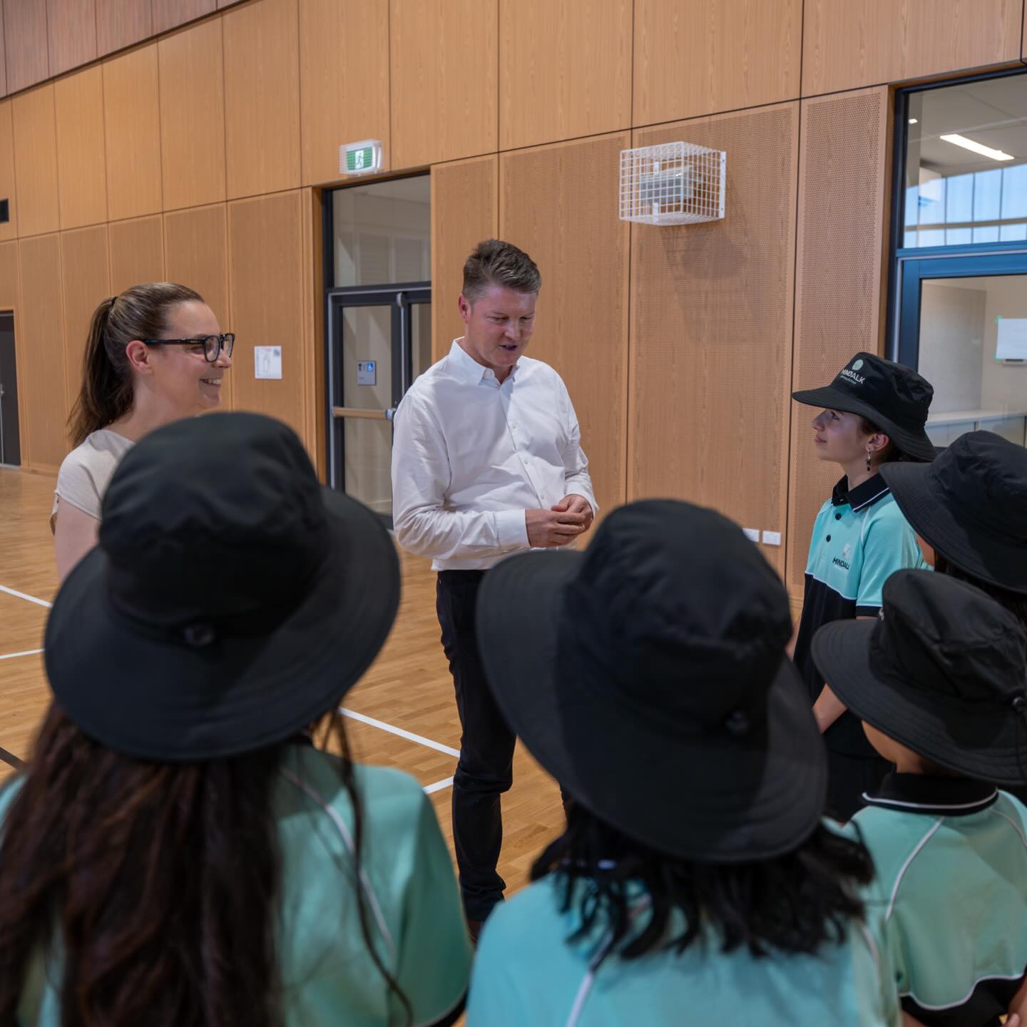 Teacher talking with students in a school gym