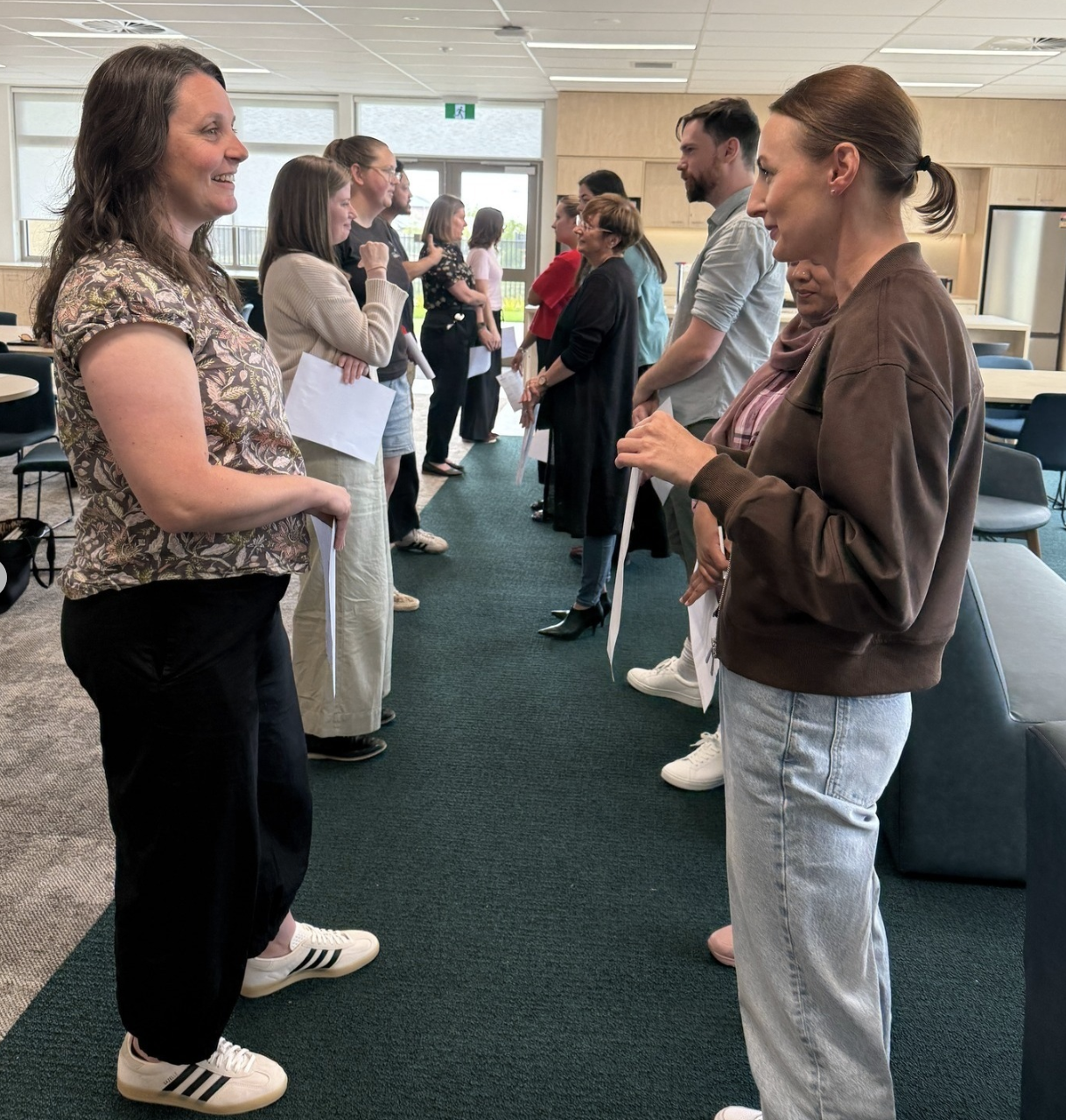 Group discussing in office corridor