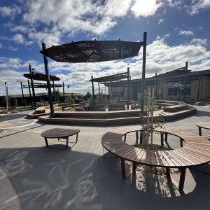 Modern outdoor seating area with shaded benches.