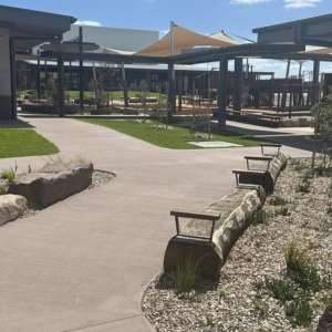 Modern school courtyard with pathways and greenery.