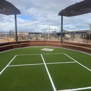 Outdoor seating area with artificial grass court